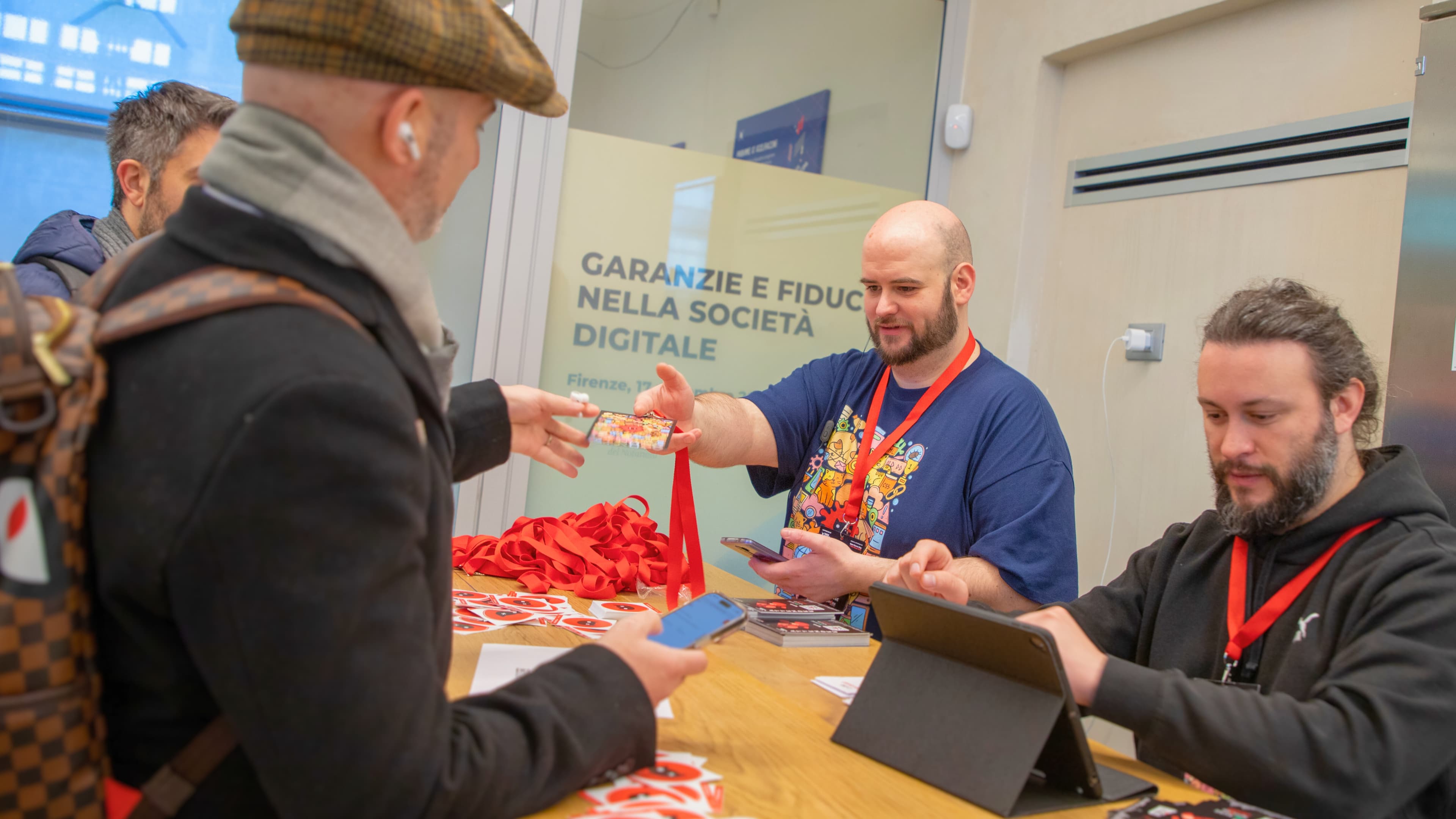 Schrödinger Hat staff handing out badges