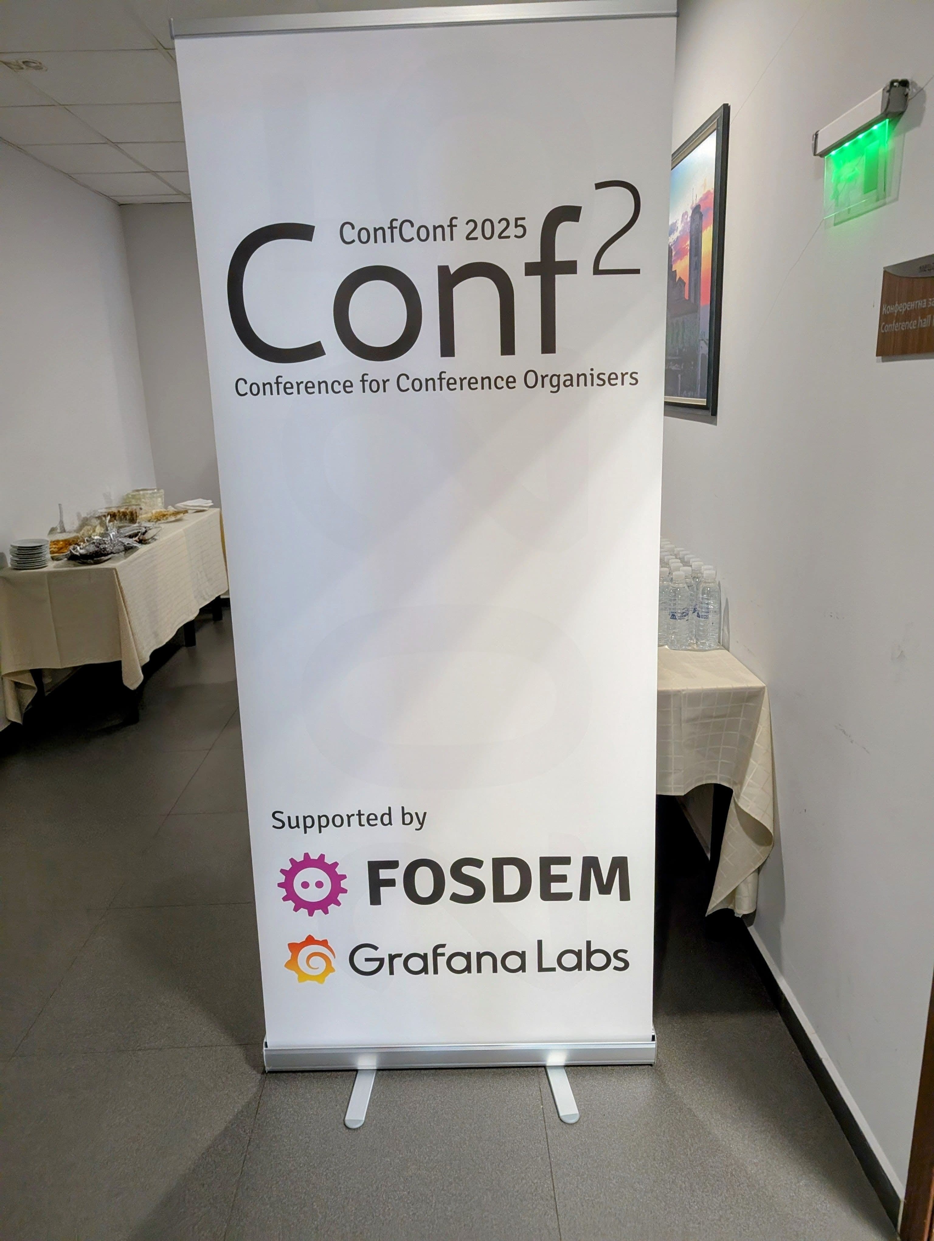 A banner displaying the title "Conf Conf 2025 - Conference for Conference Organisers" and on the bottom "Sponsored by: FOSDEM and Grafana Labs"